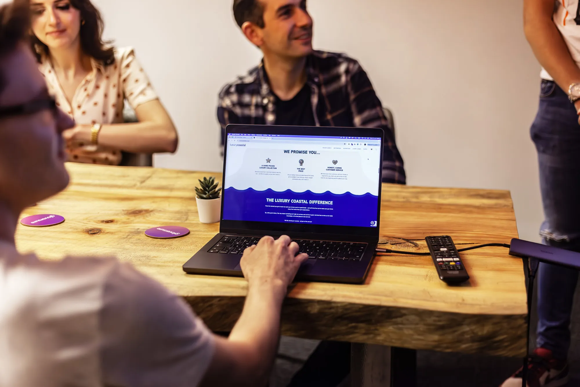 A laptop on a fabric surface showing the Beach Retreats homepage
