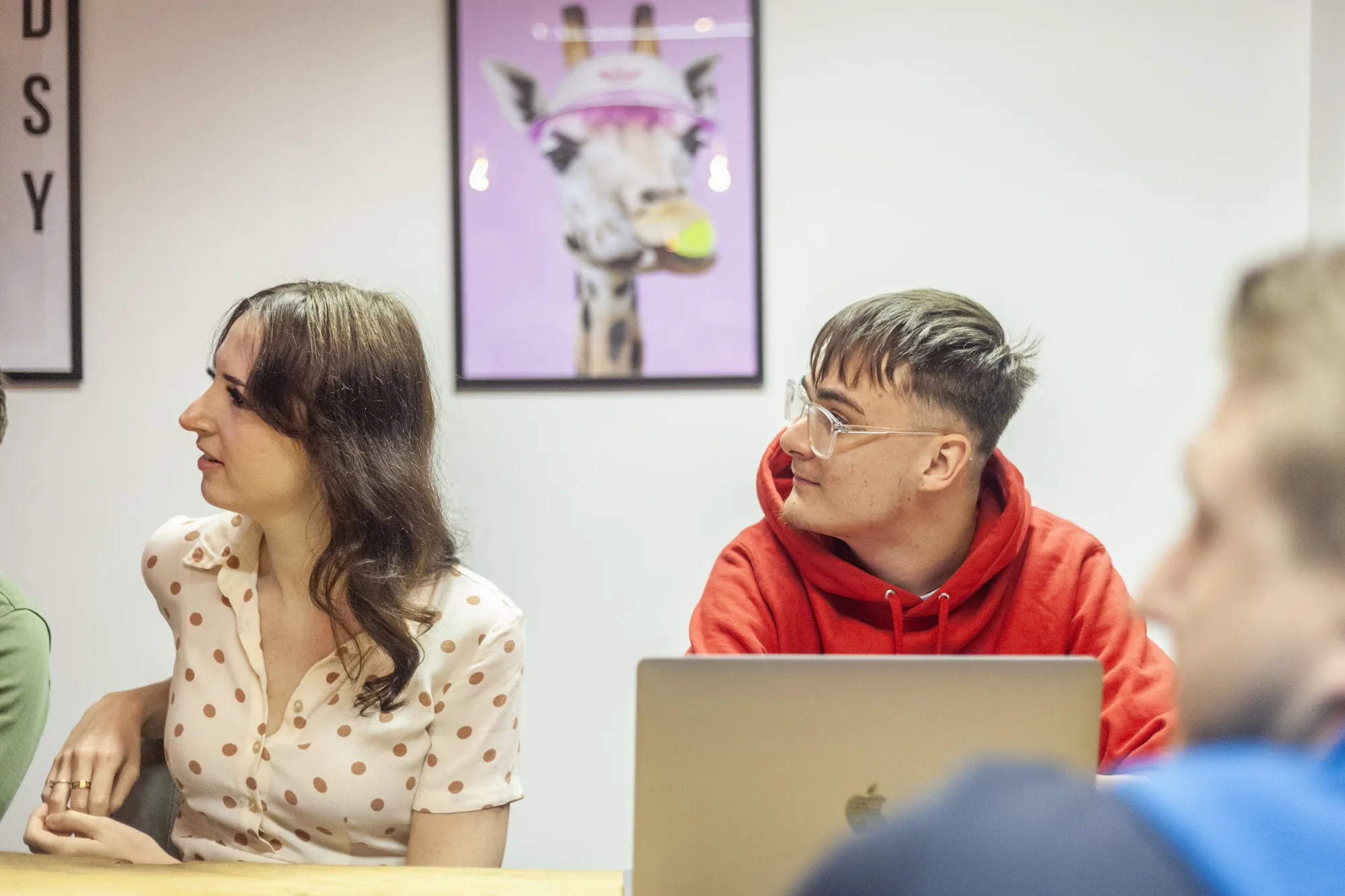A man and a woman sat in front of a laptop