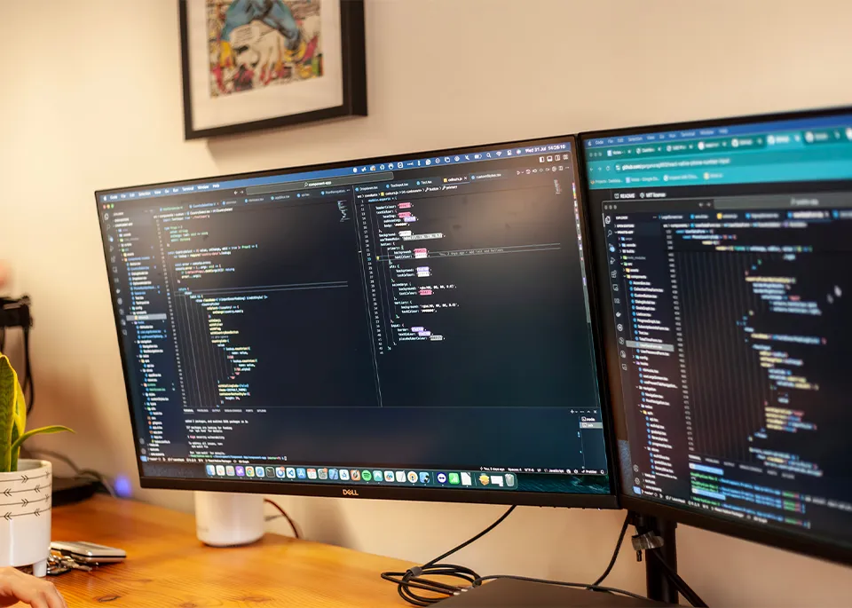 A close up of computer screens showing lines of code