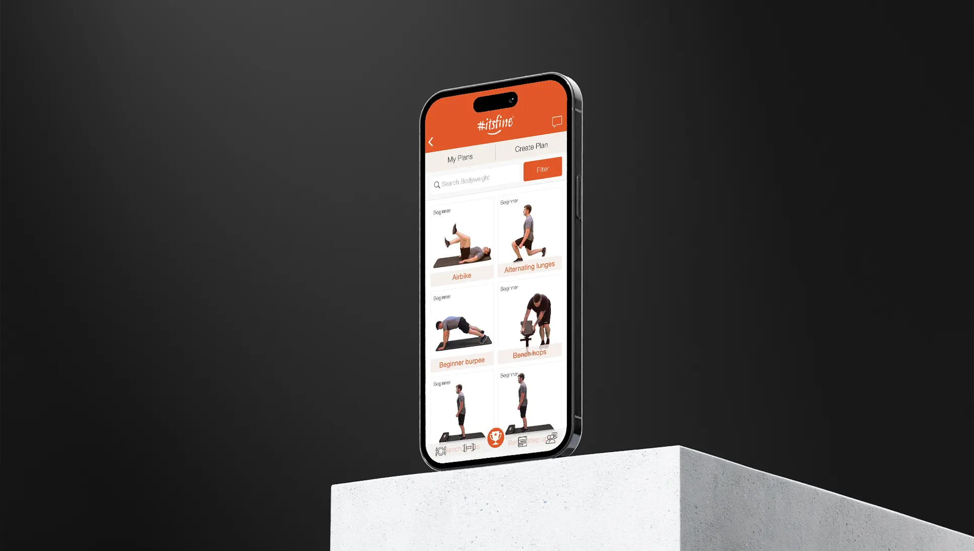 An iPhone on a concrete block showing the Itsfine exercise plans page