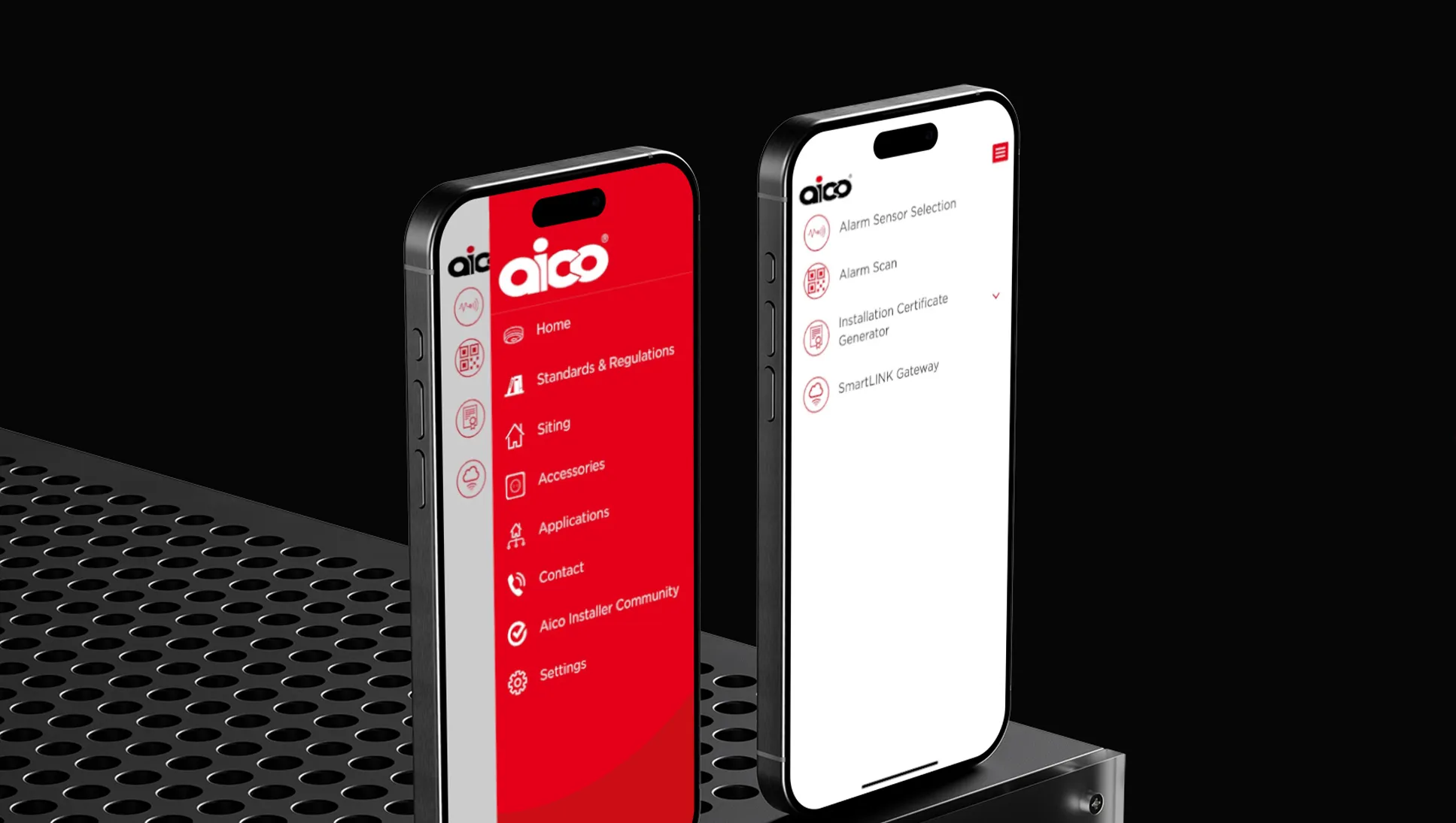 Two iPhones on a metal surface showing different pages from the Aico Handybook App