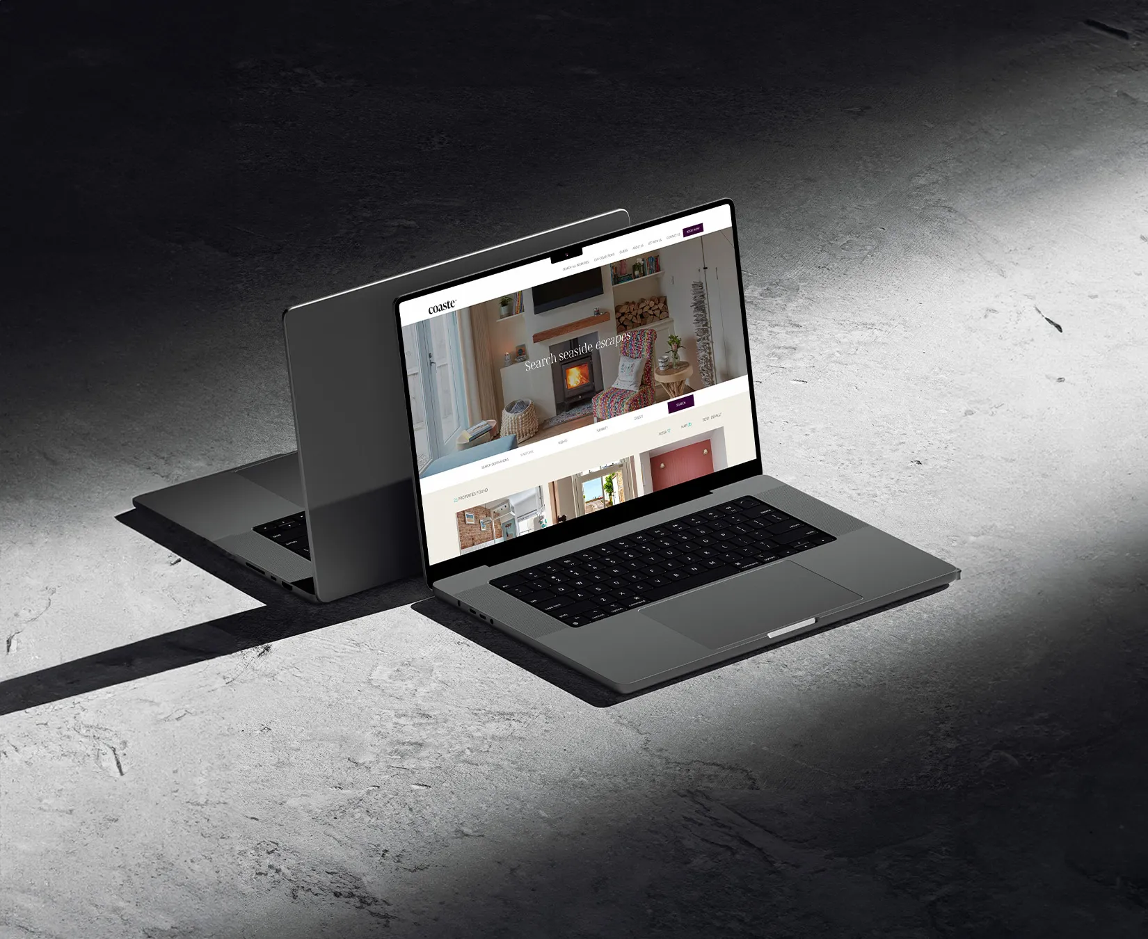 Two MacBooks back to back showing the Coaste Website