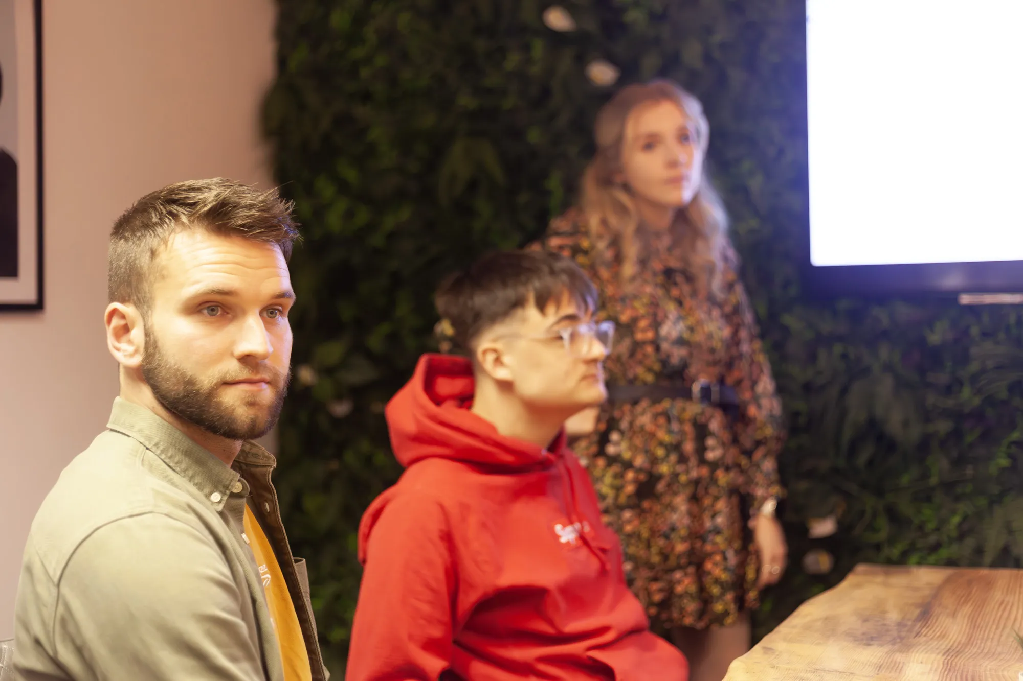 Two men sat in a meeting room looking on