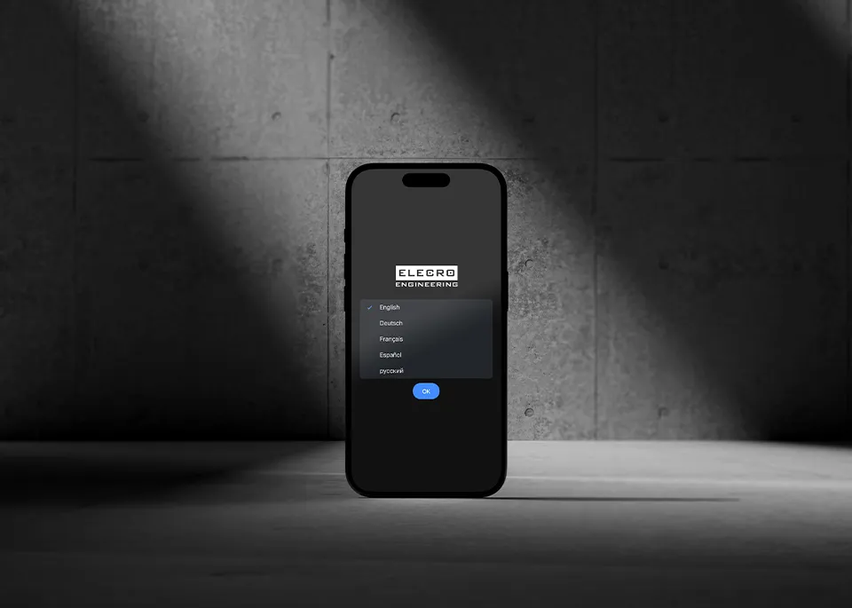 An iPhone on a concrete surface showing the Elecro App language selection page