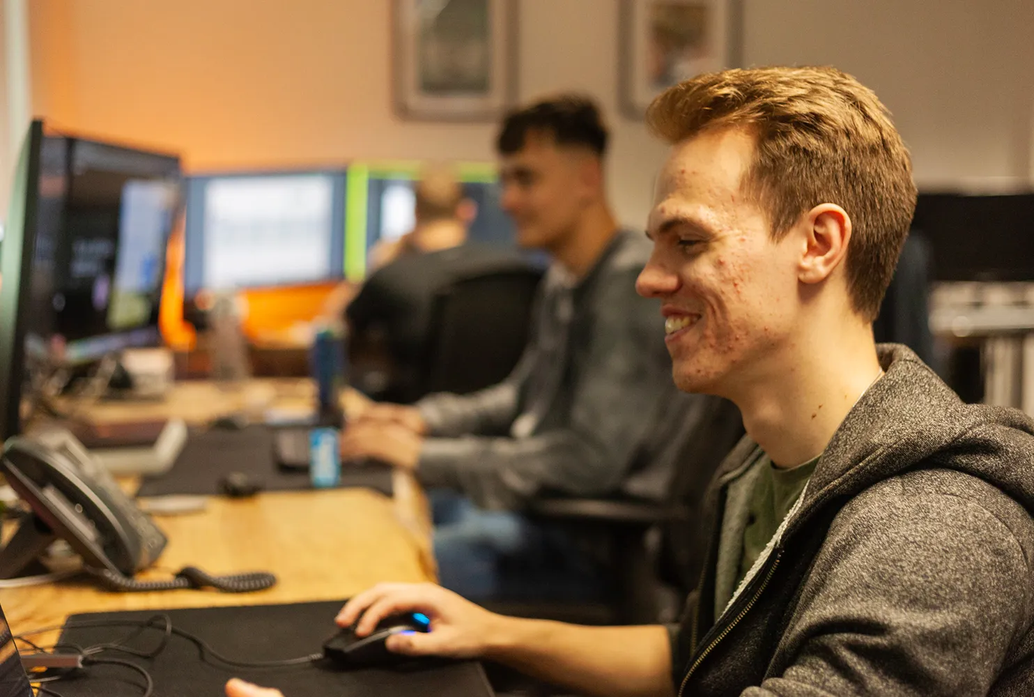 A man sitting at a desk smiling