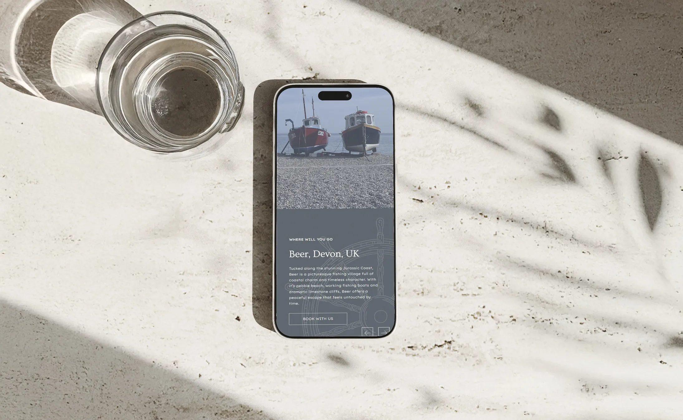 An iPhone displaying the Obstgarten Homes location section on screen