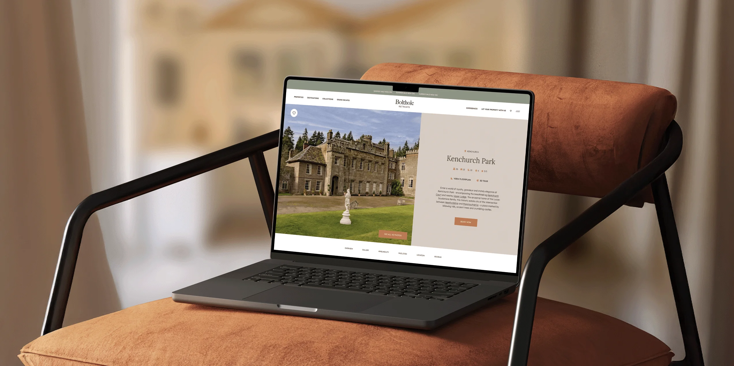 Laptop on a cushioned chair showing the Kenchurch Park property page on the Beach Retreats website.